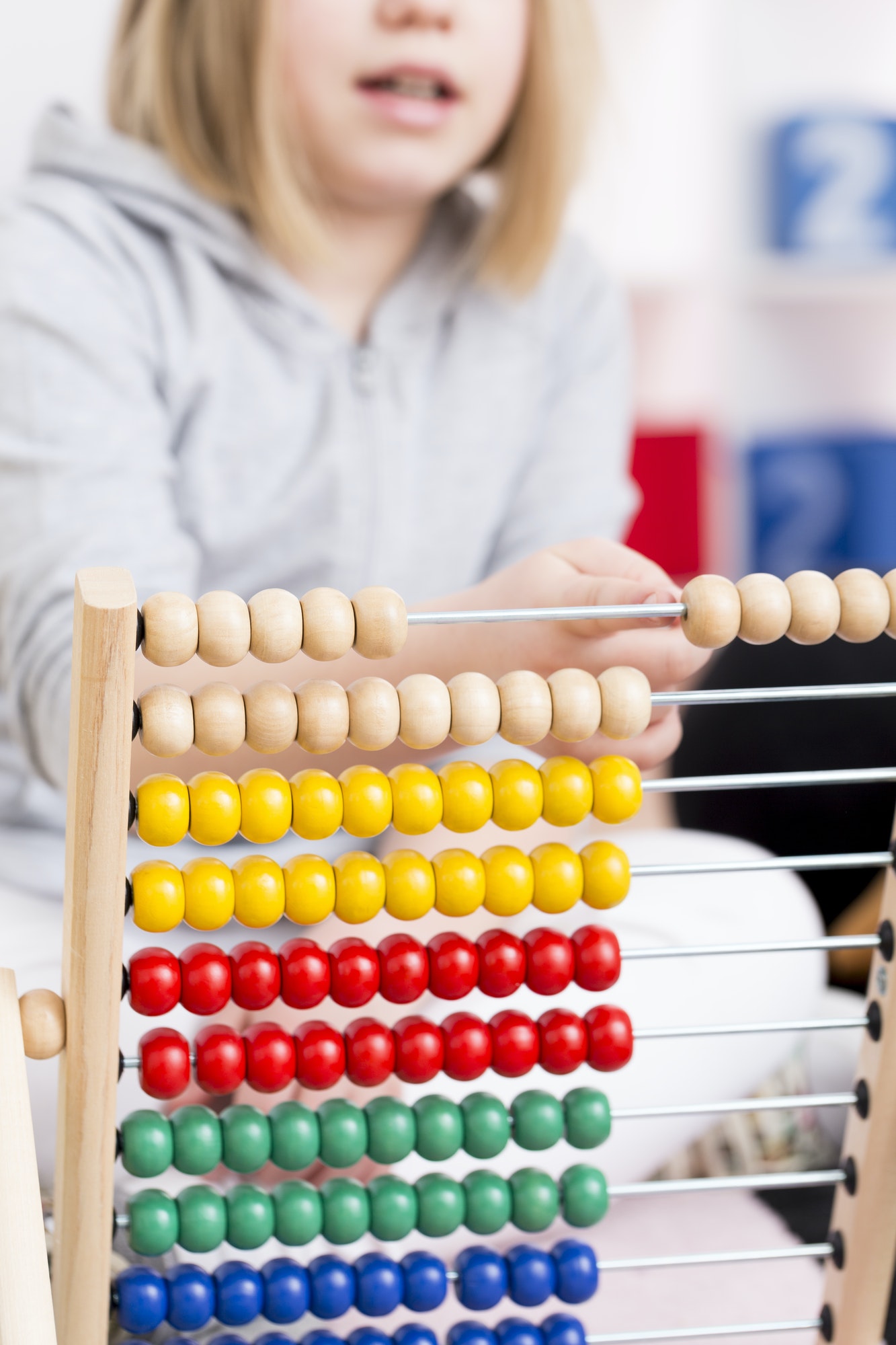 Girl learning to count using abacus